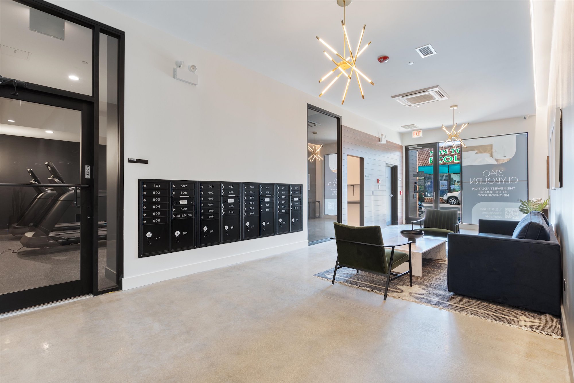 The lobby at 3140 Clybourn, new apartments in Roscoe Village Chicago. The lobby contains the package room, secure mailboxes, and the entrance to the fitness center.